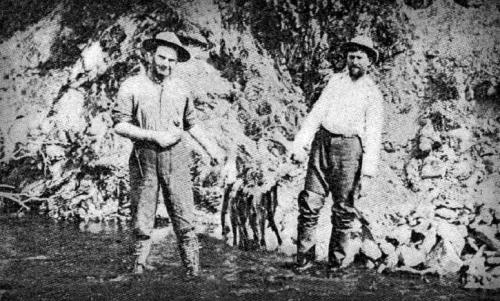Doubtless you have wondered what Geo. Watkin Evans, author of the interesting series of articles on the coal fields of the State of Washington appearing in the Bulletin, looks like. Here he is in his fishing togs. He is the figure on the left, and the pleased expression on his face comes from the fact—solemnly sworn to by Mr. Evans—that the ten fish on the string he is holding were all caught by him on one hook in ten minutes while in Alaska some years ago.