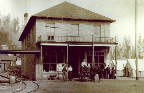 Proprietors Paul and Hannah Knoernschild, standing to the left of the horse and buggy, in the coal and clay mining town of Taylor.